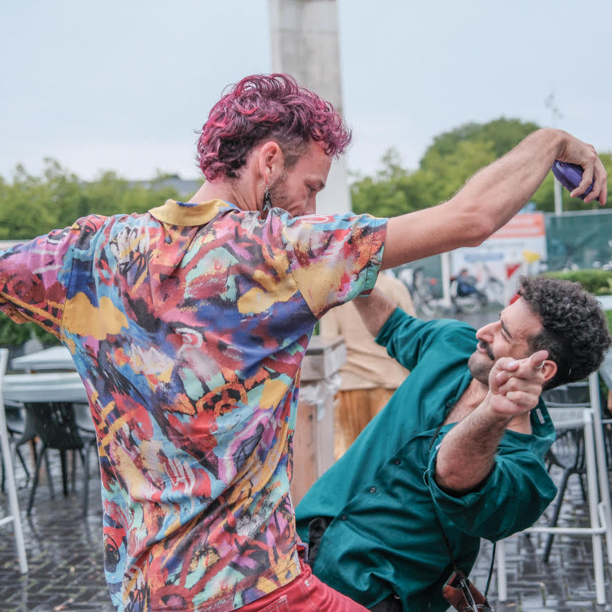 Twee mensen dansen samen buiten in een vrolijk moment
